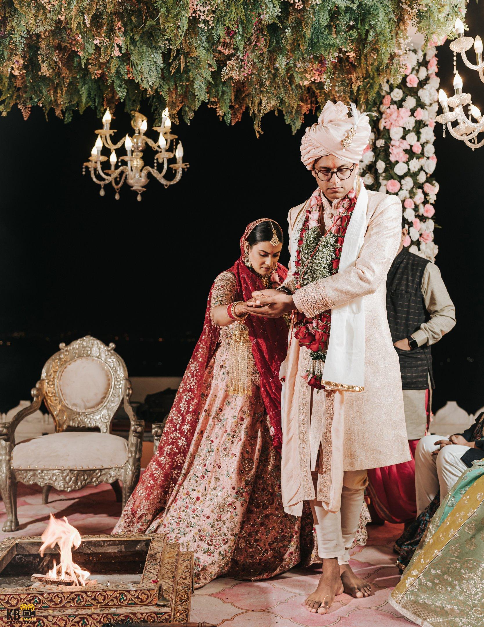 a man and woman in traditional indian wedding attire